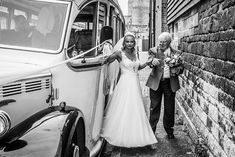 the bride and groom are getting ready to get into their wedding car