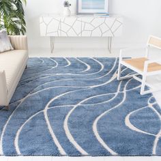 a living room with a blue rug and white furniture