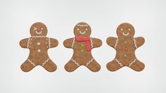 three gingerbread men are standing next to each other