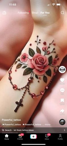 an image of a flower tattoo on someone's arm with rosarys and roses