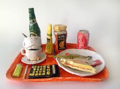 an orange tray with food and drinks on it