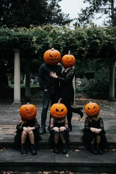 a group of people with pumpkins on their heads