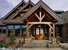 a large house with stone steps leading up to the front door and entryway area