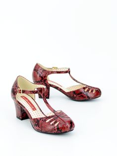 Your wardrobe will never lack personality with this chic Robbie. Shed your inhibitions and dare to stand out with exotic snake print. Experience this classic t-strap reimagined with bold colors, luxurious texture, and timeless python print. 40's Inspired Front T-Strap Heel. Proud To Be 100 % Vegan Friendly. Upper Material: Exotic Faux Snake Skin Leather Lining Material: Man Made Material + Fabric Counter Lining Sock: Fully Padded With Memory Foam For Maximum Comfort. Heel Height: 2 3/8" Inches A Velvet Purple, T Strap Heels, Python Print, Strap Pumps, Velvet Color, Vintage Velvet, Vintage Jewels, Proud To Be, T Strap