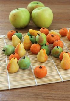 there are many different fruits on the bamboo mat