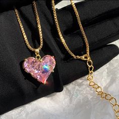 This Stunning Pink Sapphire Heart Pendant Necklace Is The Perfect Blend Of Elegance And Charm. The Heart-Shaped Crystal Sparkles With Rainbow Reflections, Beautifully Set In A Gold-Plated Chain For A Luxurious Look. The Adjustable Chain Allows For A Customized Fit, Making It A Versatile Piece For Any Occasion, Whether Casual Or Formal. Condition: Brand New, Never Worn. Details: - Gold-Plated Chain - Pink Lab Sapphire Heart Pendant - Adjustable Chain For A Perfect Fit - Eye-Catching And Glamorous Heart Cut Charm Jewelry For Party, Pink Heart Beads Jewelry For Anniversary, Heart Cut Jewelry With Heart Charm For Party, Party Jewelry With Heart Cut Charm, Heart Pendant Jewelry For Mother's Day Party, Pink Gold Heart Charm Pendant Jewelry, Pink Heart Cut Jewelry For Valentine's Day, Feminine Heart Charm Jewelry For Party, Pink Gold Plated Necklace For Anniversary