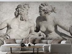 a living room with two statues on the wall