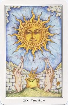 the sun tarot card is shown with two women holding up their hands in front of them