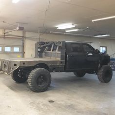 a large black truck parked in a garage