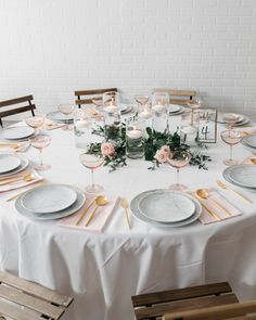 a table set with plates and place settings