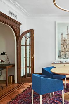 a dining room table with blue chairs around it