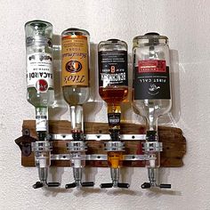 a wall mounted shelf with several different types of liquor