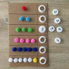 a board game with felt balls and numbers on it