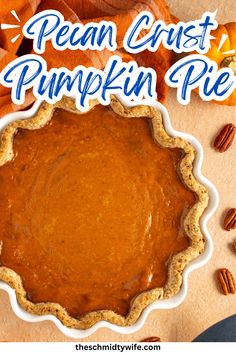 a pumpkin pie with pecans around it