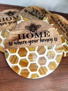 three wooden coasters with the words home is where your honey is