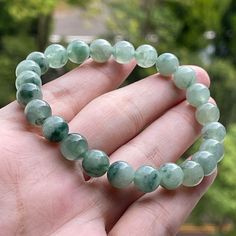 "Detail Specification Shape : Round Bead Approx Bead Size : 8~8.2 mm Bead Count : 24 pcs Weight : 23 g (115 ct) Width : 16.5 cm (6.5\") inner perimeter Color : Faint Green, Dark Green Texture : Fine Transparency: Translucent Cord : Green Elastic String Country of origin : Myanmar (Burma). Jadeite Bracelet Description * This Jadeite Jade Bead Bracelet is Free of Treatment from Artificial coloring /Polymer infilled . Jade Beads are 100% natural and categorized as Type A (Grade A) Jadeite. 24 piece Jade Crystal Bracelet, Dark Green Texture, Jade Properties, Jade Bead Bracelet, Imperial Jade, Jade Charm, Green Texture, Shipping Label, Jade Bracelet