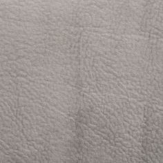 an up close shot of the texture of a gray fabric with no pattern on it