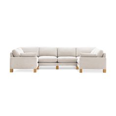 a white sectional couch with wooden legs on a white background, it's facing the camera