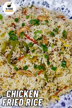 chicken fried rice with peppers and green onions on a blue and white floral pattern plate