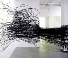 an abstract sculpture is shown in the middle of a room with white walls and floors