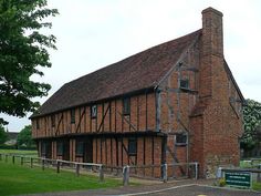 an old brick building with a wooden fence around it