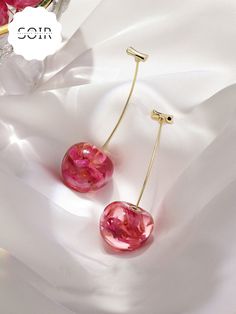 Embrace nature’s beauty with a twist of fun in the FloraCherry Botanical Drop Earrings. These stunning earrings feature long, dangling cherry motifs, each with a glossy red resin "cherry" encasing delicate dried flowers within. The natural blooms are perfectly preserved, adding a touch of earthy elegance to the playful design. Finished with sleek green stems, these earrings are a unique blend of botanical charm and vibrant style, making them the perfect statement accessory for any look. Lightwei Trendy Cherry-colored Earrings, Trendy Cherry Dangle Earrings, Cherry-colored Jewelry For Valentine's Day Party, Red Drop Earrings For Spring, Cherry Color Jewelry For Valentine's Day Party, Cherry Jewelry For Valentine's Day Party, Cherry Colored Jewelry For Valentine's Day Party, Trendy Red Resin Earrings, Cherry Color Earrings For Summer Party