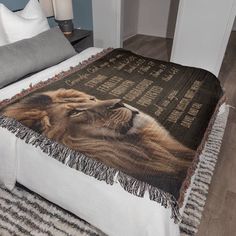 a bed with a lion blanket on top of it