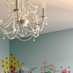 a chandelier hanging from the ceiling in a child's room