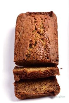 three slices of banana bread stacked on top of each other in front of a white background