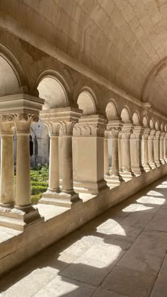 a row of stone pillars sitting next to each other on top of a cement floor