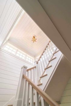 an open staircase leading up to the second floor in a house with white walls and wood floors