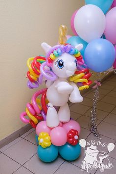 there is a balloon unicorn on top of some balloons