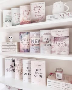 some books are sitting on the shelves next to each other in front of a coffee mug