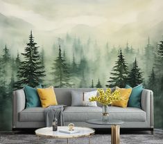 a living room with a couch, coffee table and wall mural