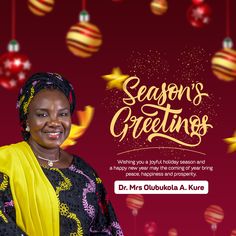 a woman wearing a yellow scarf standing in front of red and gold christmas decorations with the words season's greetings on it