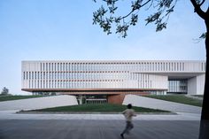 a person walking in front of a large building