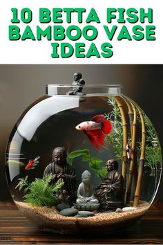 an aquarium filled with fish and plants on top of a wooden table next to bamboo sticks