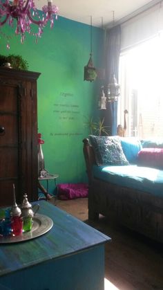 a living room filled with furniture and a chandelier hanging over the top of it