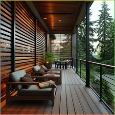 a wooden porch with chairs and tables next to the trees on the other side is covered in wood slats