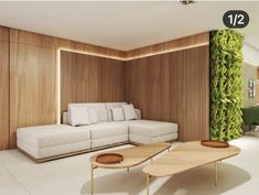 a living room with white furniture and wood paneling on the walls, along with plants growing on the wall