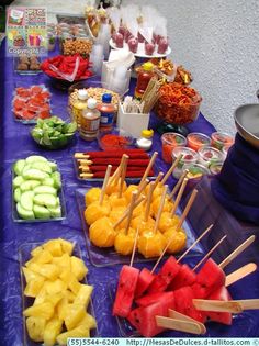 a table topped with lots of fruits and veggies on skewered sticks