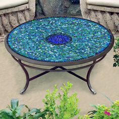 a blue mosaic table sitting on top of a patio