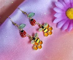 From my Backyard Wildlife collection! 🦋 A pair of lovely fairycore dangle earrings featuring a tiny bee with rhinestones, honeycomb, cute ladybug and transparent green glass leaf 🌿 🐝  - in gold tone. These earrings will be absolutely perfect for any fan all things fairy, garden, nature, cottagecore aesthetic, insect and other woodland creatures lovers. They can make a creative gift for any pixie in your life :) ️  I have many cottage or fairy core themed earrings: mismatched bee and honeycomb Nature Cottagecore, Ladybug Earrings, Bee Honeycomb, Aesthetic Gift, Insect Jewelry, Cottagecore Aesthetic, Woodland Creatures, Fairy Core, Creative Gifts