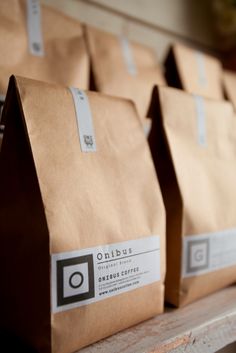 three brown bags sitting on top of a wooden table