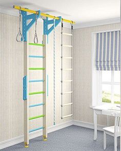 a child's play room with ladders and toys hanging from the ceiling in front of a window