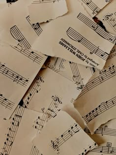 old sheet music notes are piled on top of each other