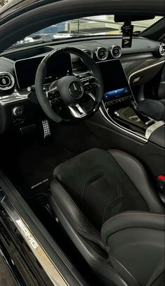 the interior of a car with black leather seats and steering wheel, dash board and dashboard