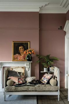 a living room filled with furniture and a painting on the wall