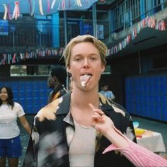 a man is brushing his teeth in front of some people