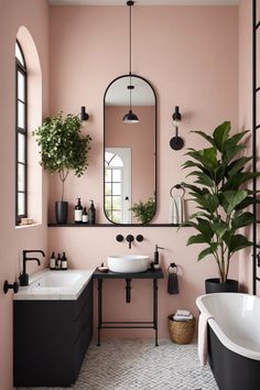 a bathroom with pink walls, black fixtures and a large mirror on the wall above the sink